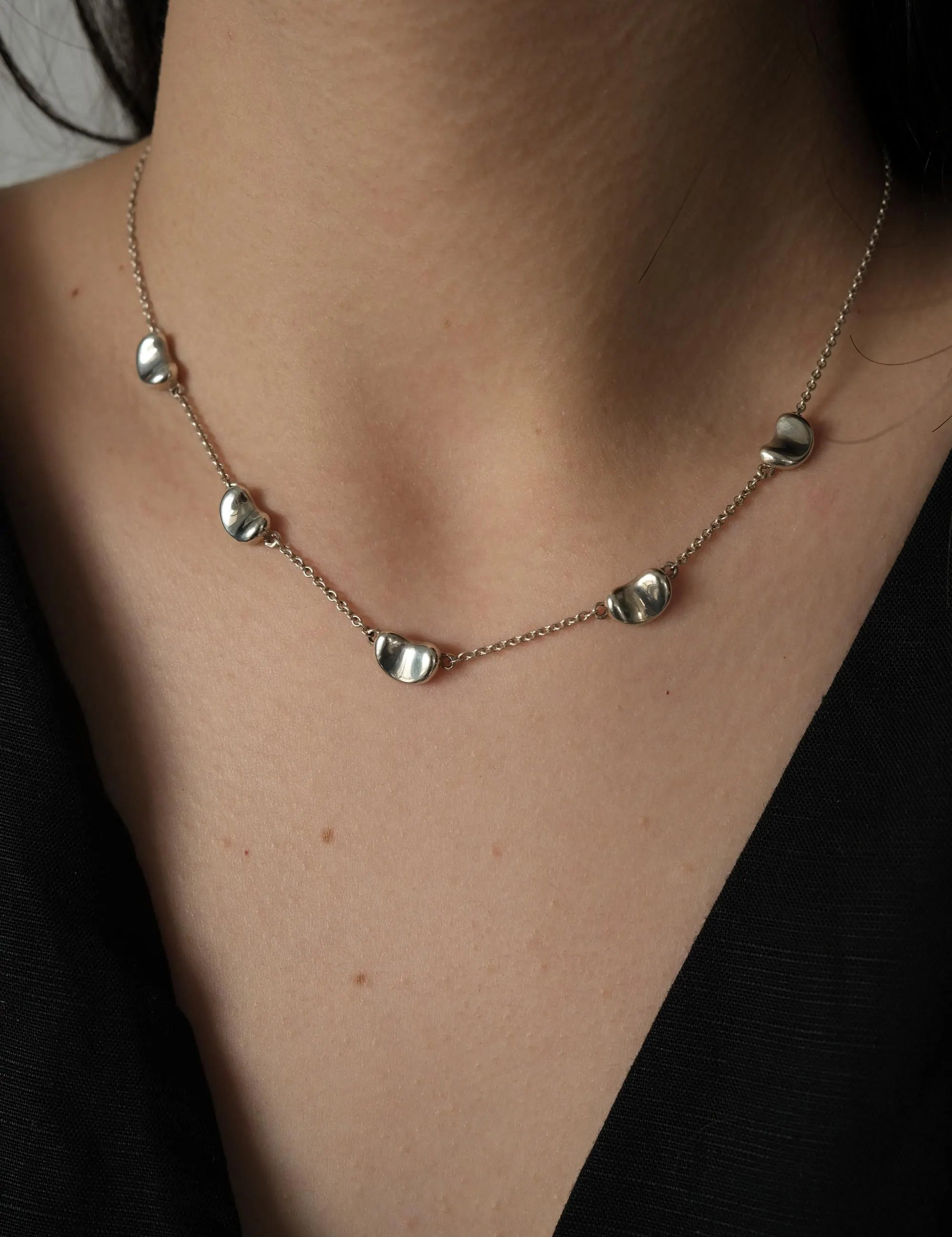 Vintage Tiffany & Co Elsa Peretti Five Bean necklace in sterling silver 925 featuring five polished sculptural Bean motifs