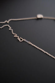 Close-up of delicate sterling silver chain connecting the five Bean motifs on vintage Tiffany & Co necklace