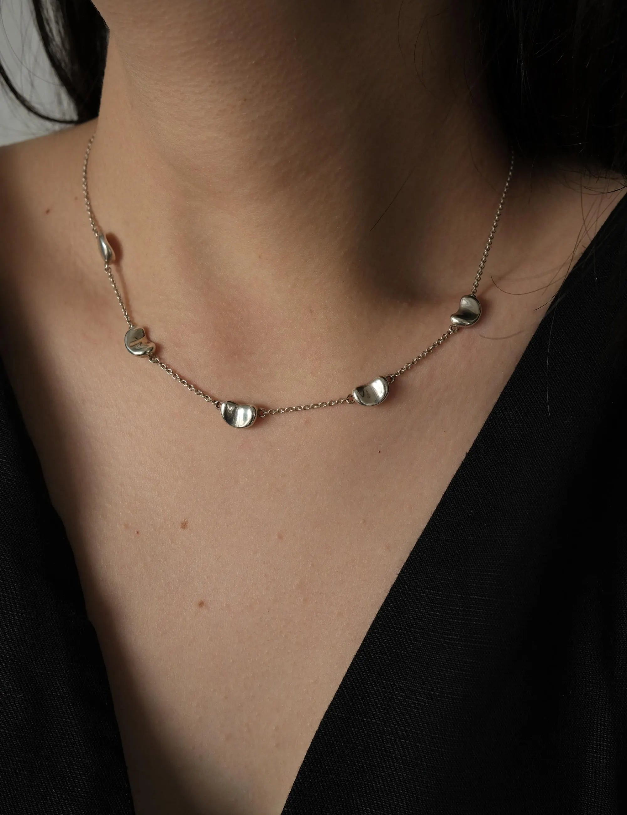 Vintage Tiffany & Co Elsa Peretti sterling silver Five Bean necklace styled with a minimalist black top