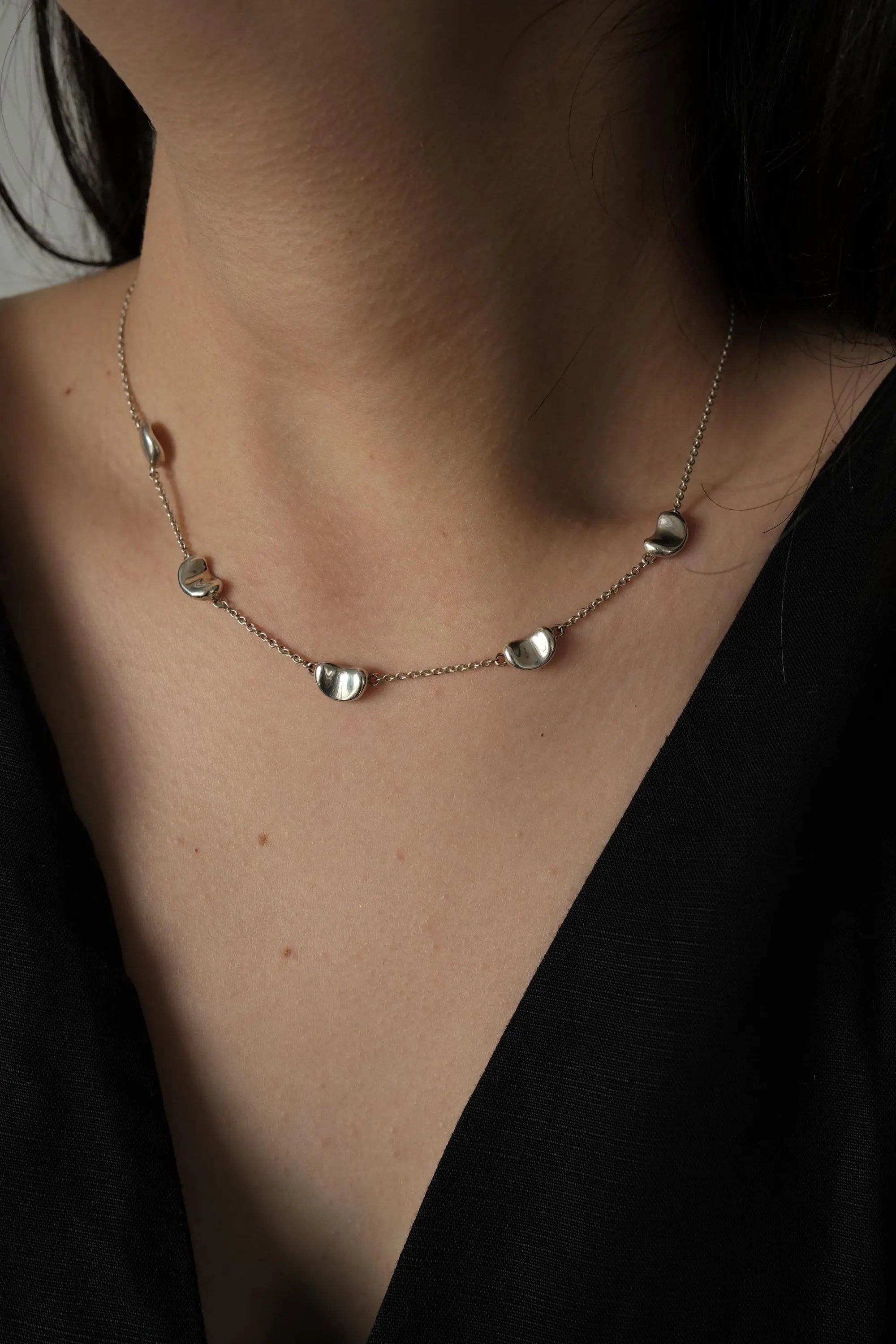 Vintage Tiffany & Co Elsa Peretti sterling silver Five Bean necklace styled with a minimalist black top