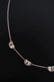 Detailed view of smooth sculptural Bean design on Tiffany & Co Elsa Peretti vintage sterling silver necklace