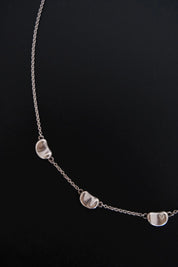 Detailed view of smooth sculptural Bean design on Tiffany & Co Elsa Peretti vintage sterling silver necklace