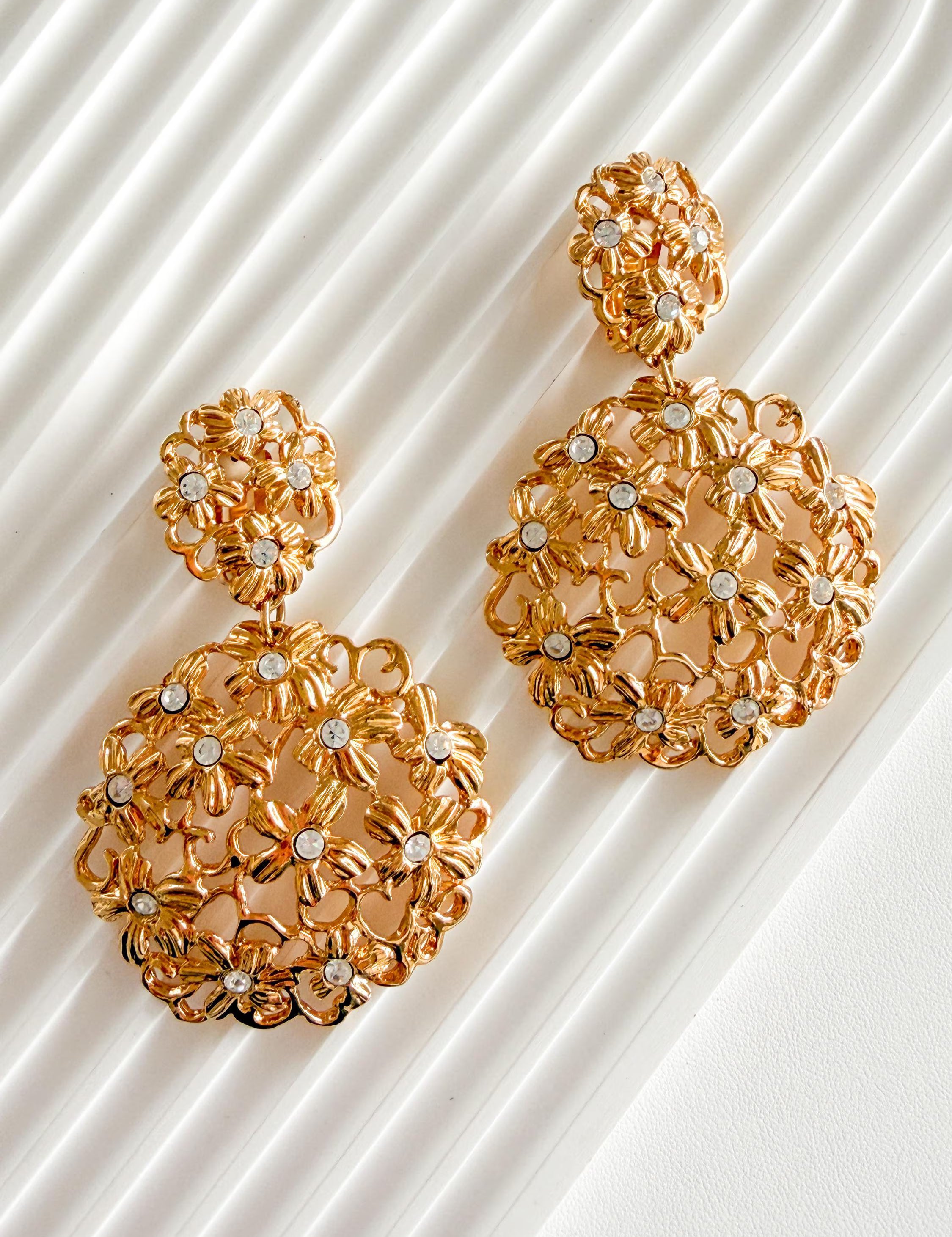 Luxury vintage YSL gold floral statement earrings with rhinestones for elegant women