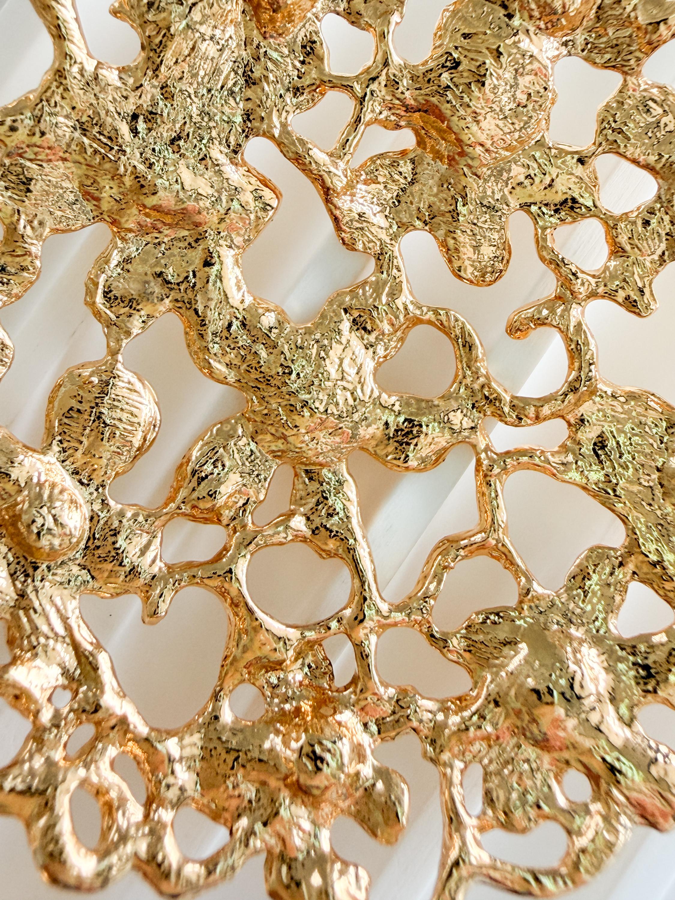 Close up vintage YSL earrings gold floral design with sparkling rhinestone details