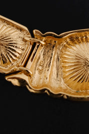 Close-up of sculptural ribbed fan-like gold-tone metal details separating the crystals on Yves Saint Laurent necklace