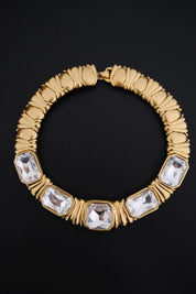 Full view of vintage YSL sculptural gold-tone collar necklace featuring five large clear crystals and architectural ribbed details