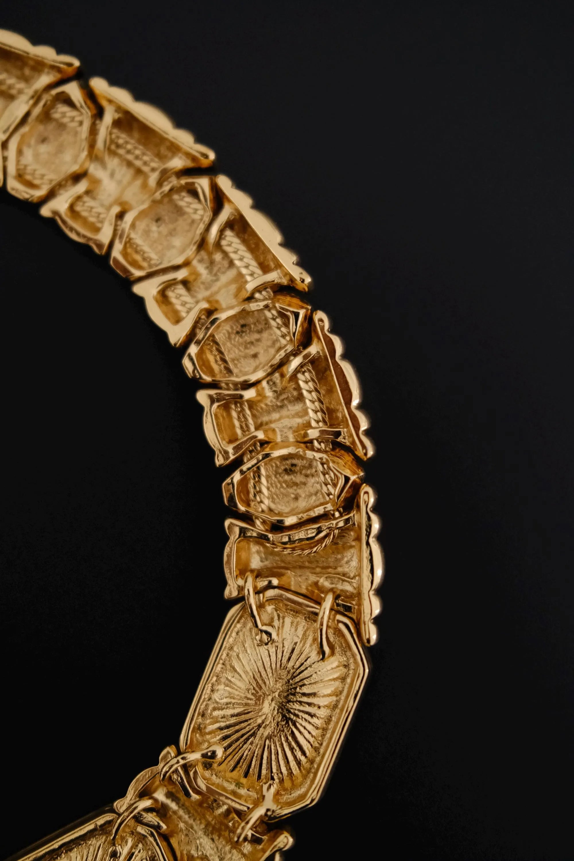 Back view of vintage Yves Saint Laurent gold-tone crystal collar necklace showing curved construction and closure