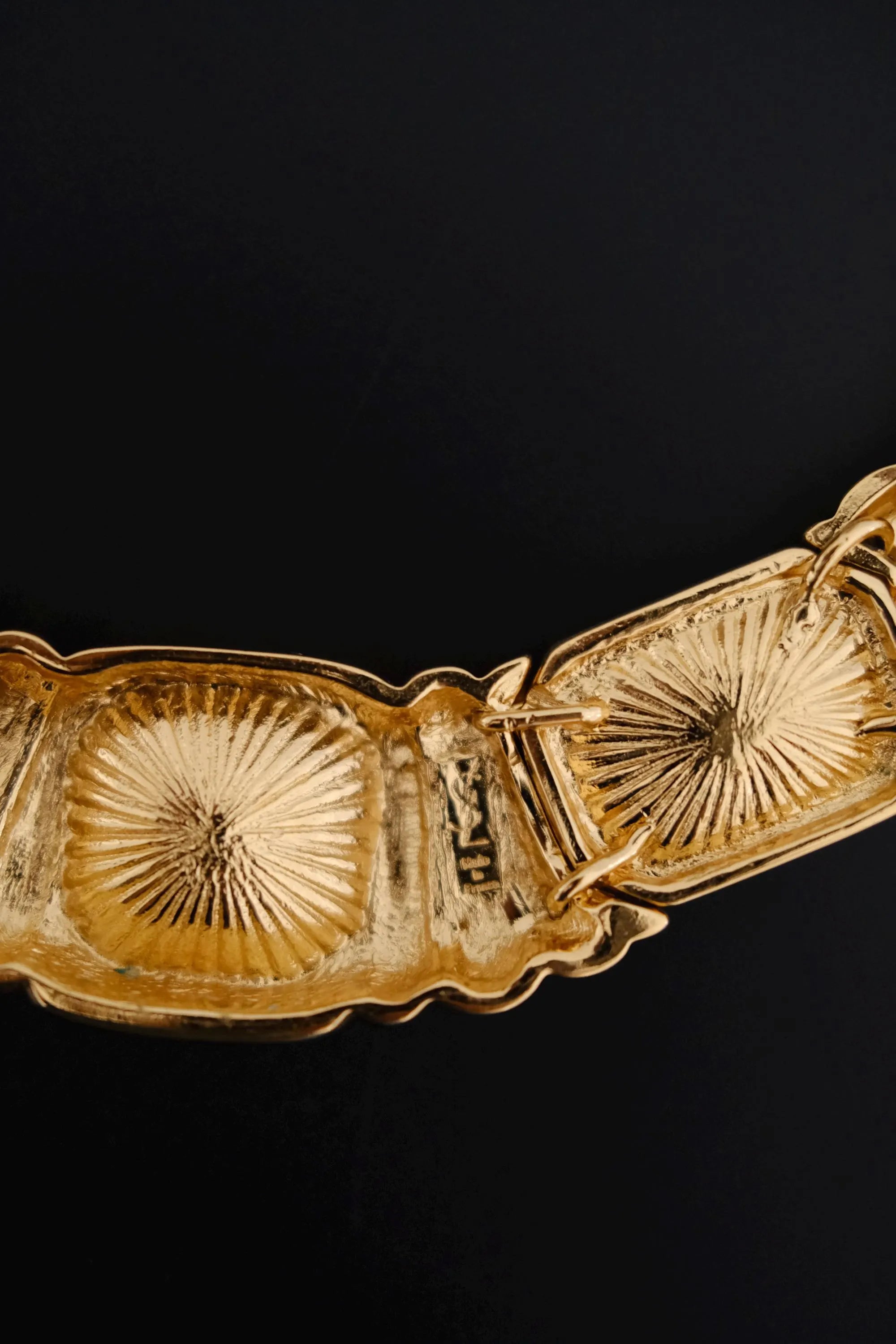 Close-up of Yves Saint Laurent signature marking on vintage gold-tone crystal collar necklace
