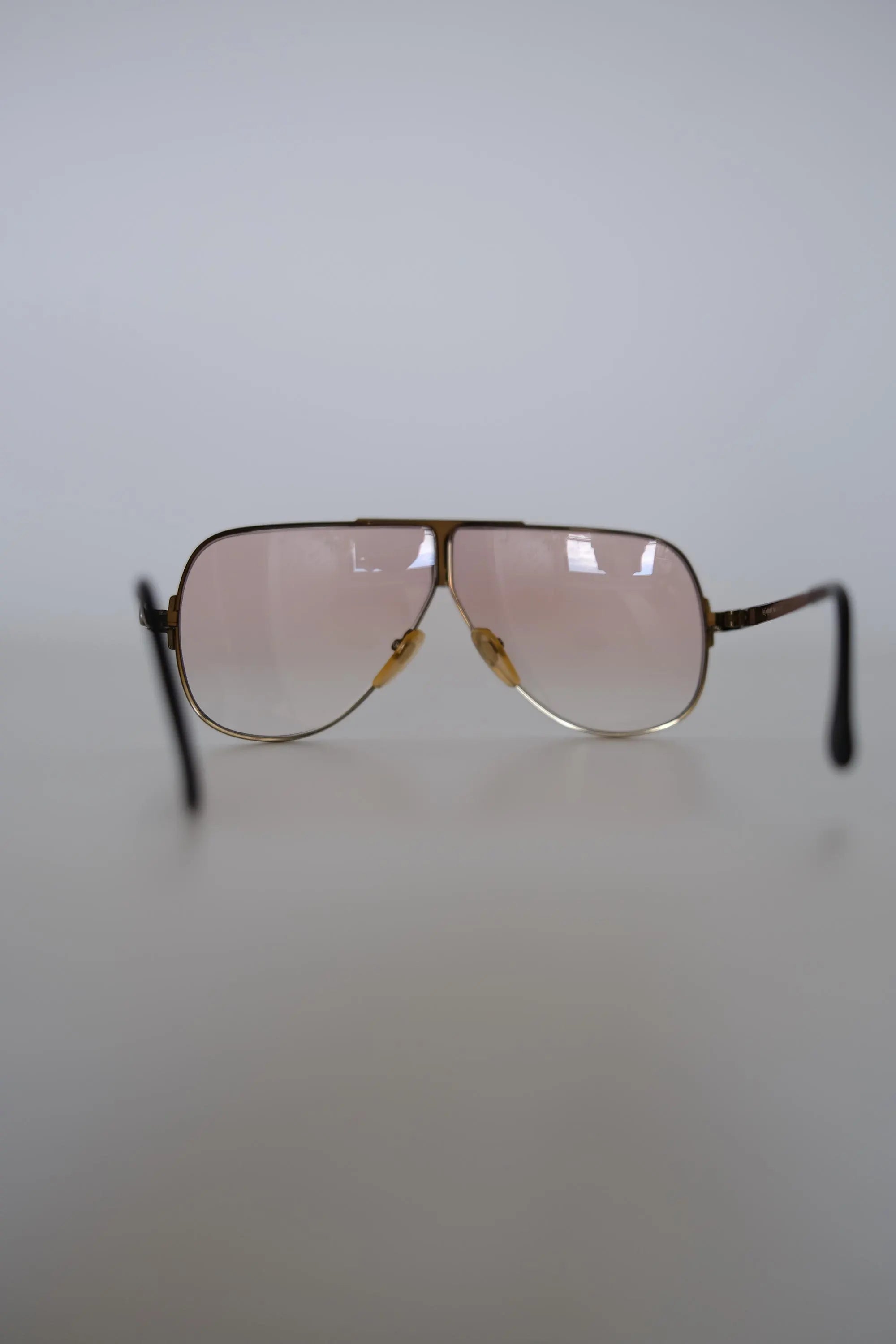 Close-up of distinctive architectural brow bar and double bridge construction on vintage YSL aviator sunglasses