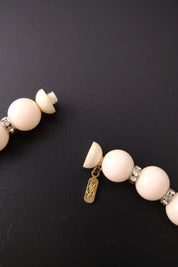 YSL signature logo charm at the closure of vintage beige crystal beaded choker necklace