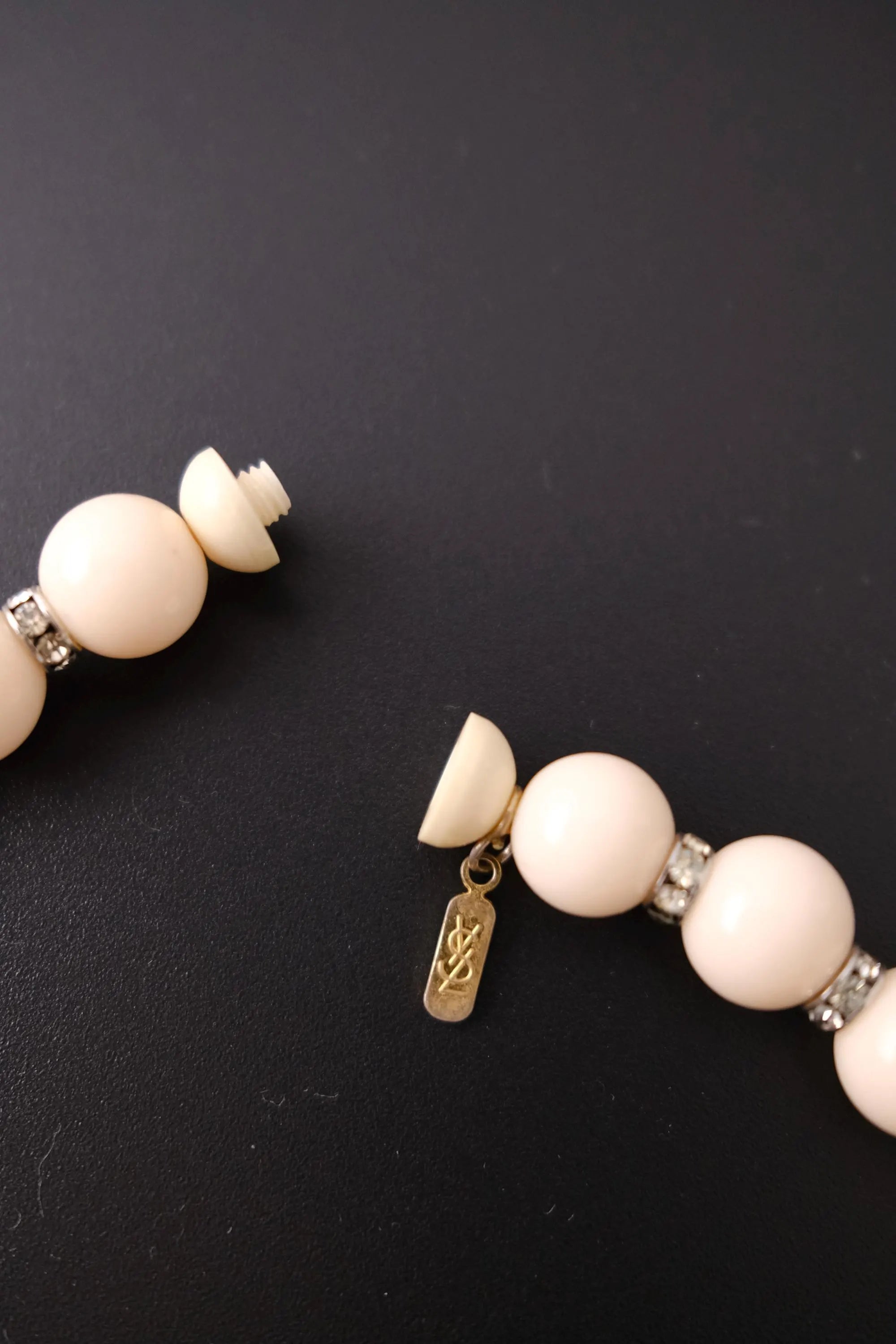 YSL signature logo charm at the closure of vintage beige crystal beaded choker necklace