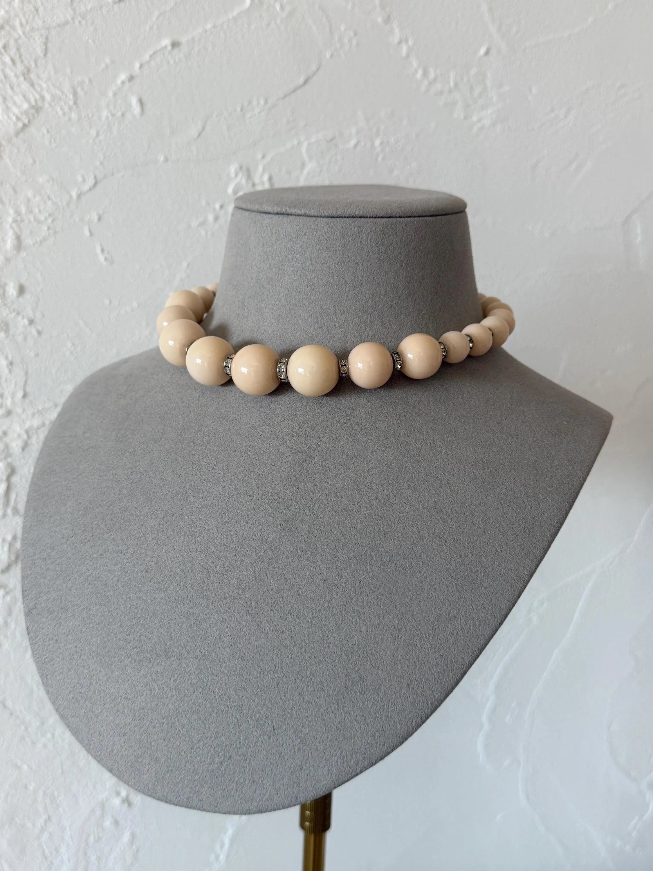 Vintage Yves Saint Laurent beige graduated bead choker necklace worn elegantly around the neckline