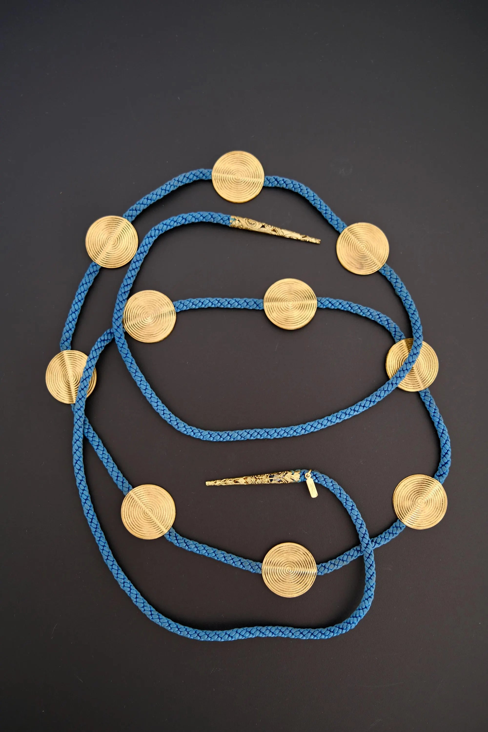 Vintage Yves Saint Laurent YSL blue braided cord belt necklace with textured gold-tone spiral medallions