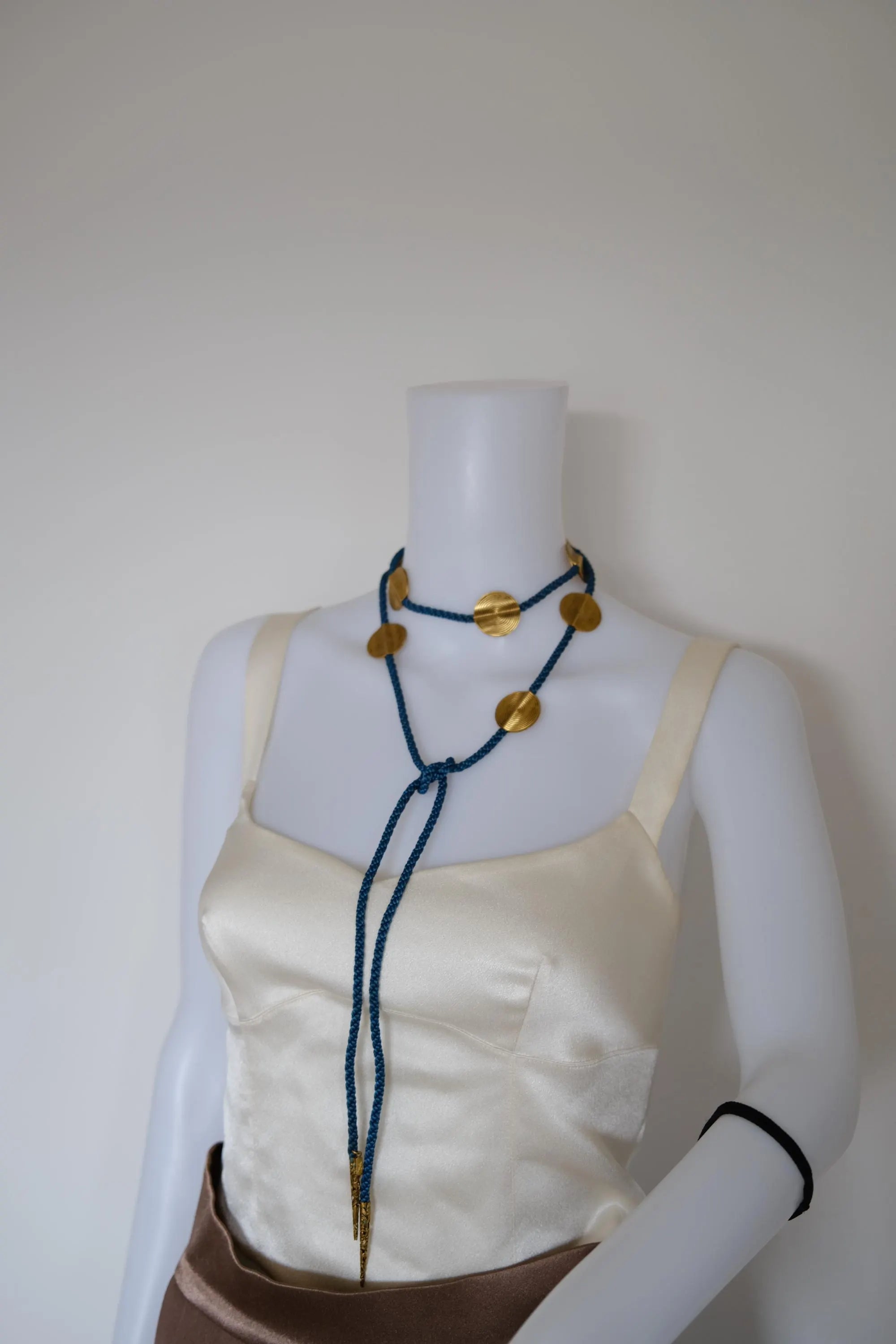 Full view of vintage Yves Saint Laurent convertible blue and gold belt necklace measuring 150 cm