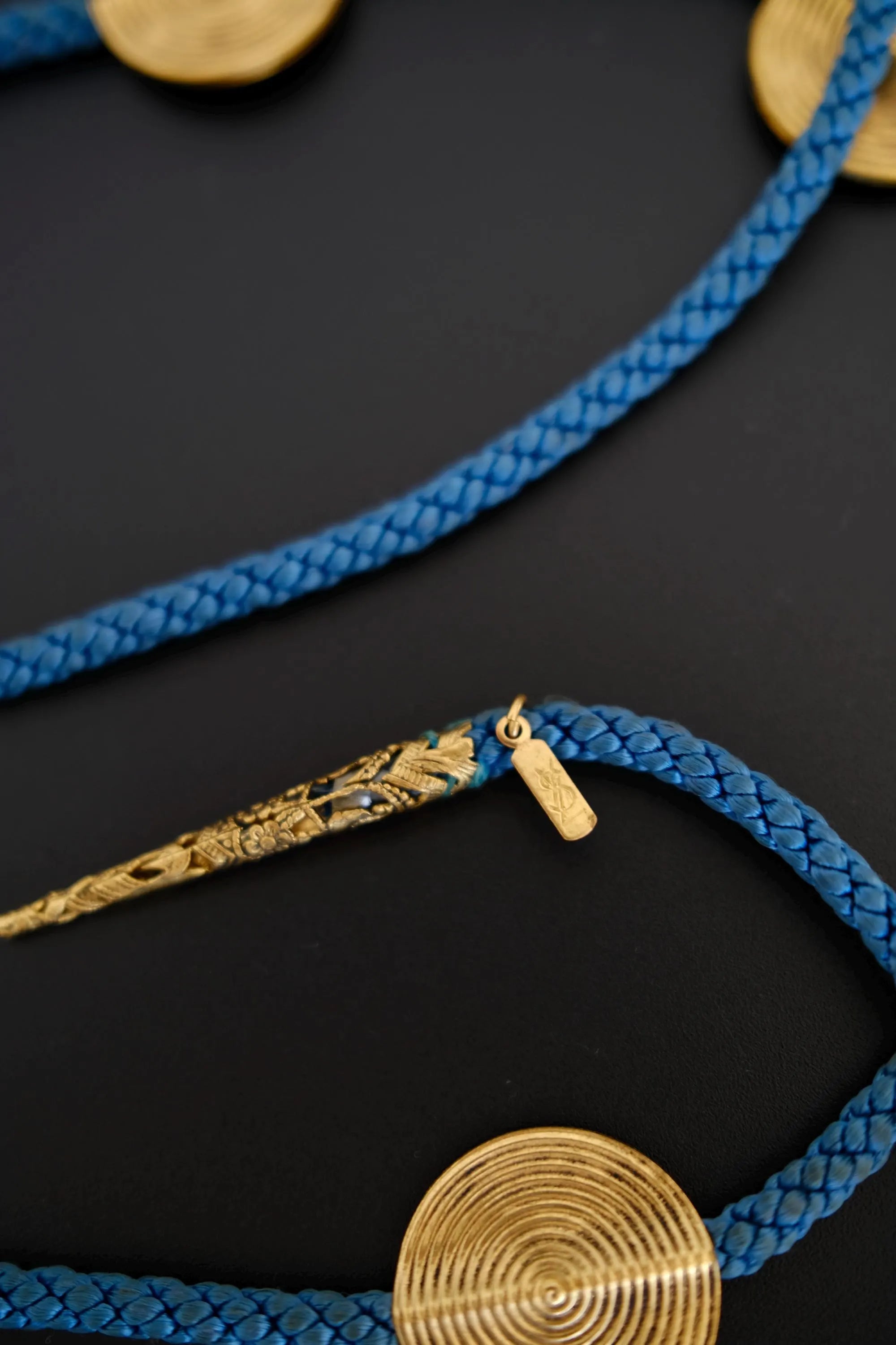 Detail of deep blue braided cord on vintage Yves Saint Laurent convertible belt necklace