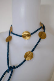 Vintage Yves Saint Laurent blue and gold medallion necklace styled as a long statement necklace