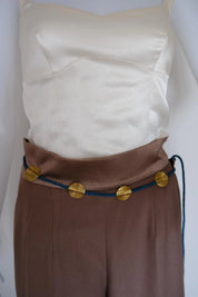 Vintage YSL blue braided cord medallion belt styled around the waist with gold-tone accents