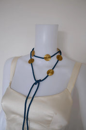 Yves Saint Laurent vintage blue cord necklace styled as a lariat with round gold-tone medallions