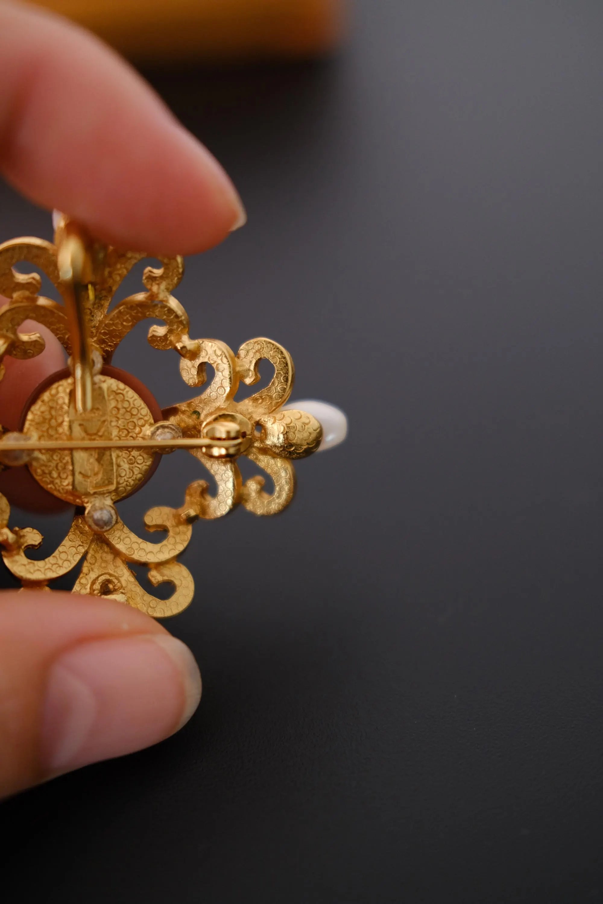 YSL Made in France signature on YSL Made in France signature on reverse of vintage Yves Saint Laurent brooch