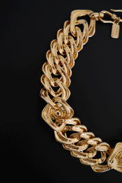 Detailed view of sculptural interlocking gold-tone chain links on vintage Yves Saint Laurent necklace