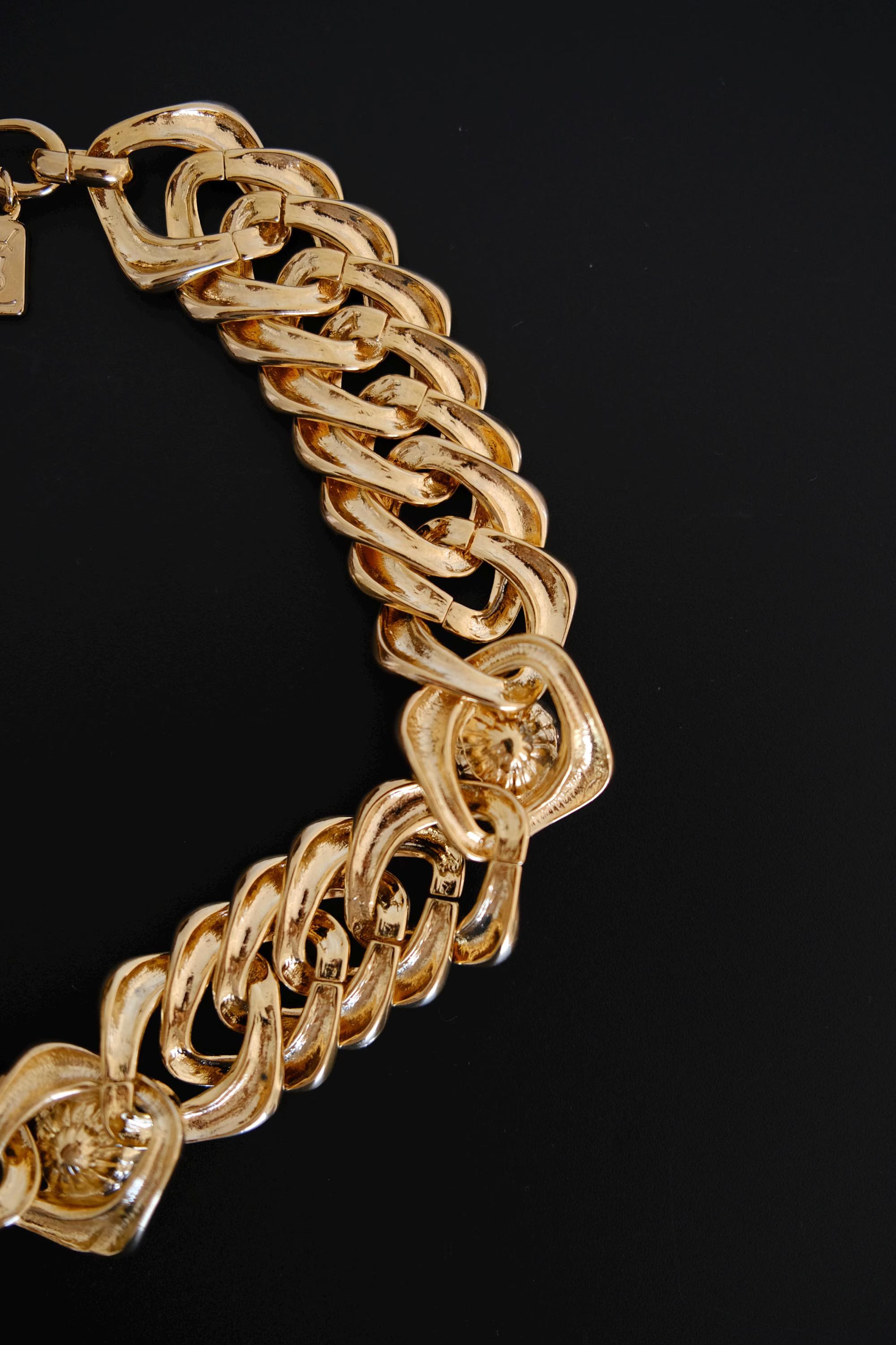 Detailed view of sculptural interlocking gold-tone chain links on vintage Yves Saint Laurent necklace