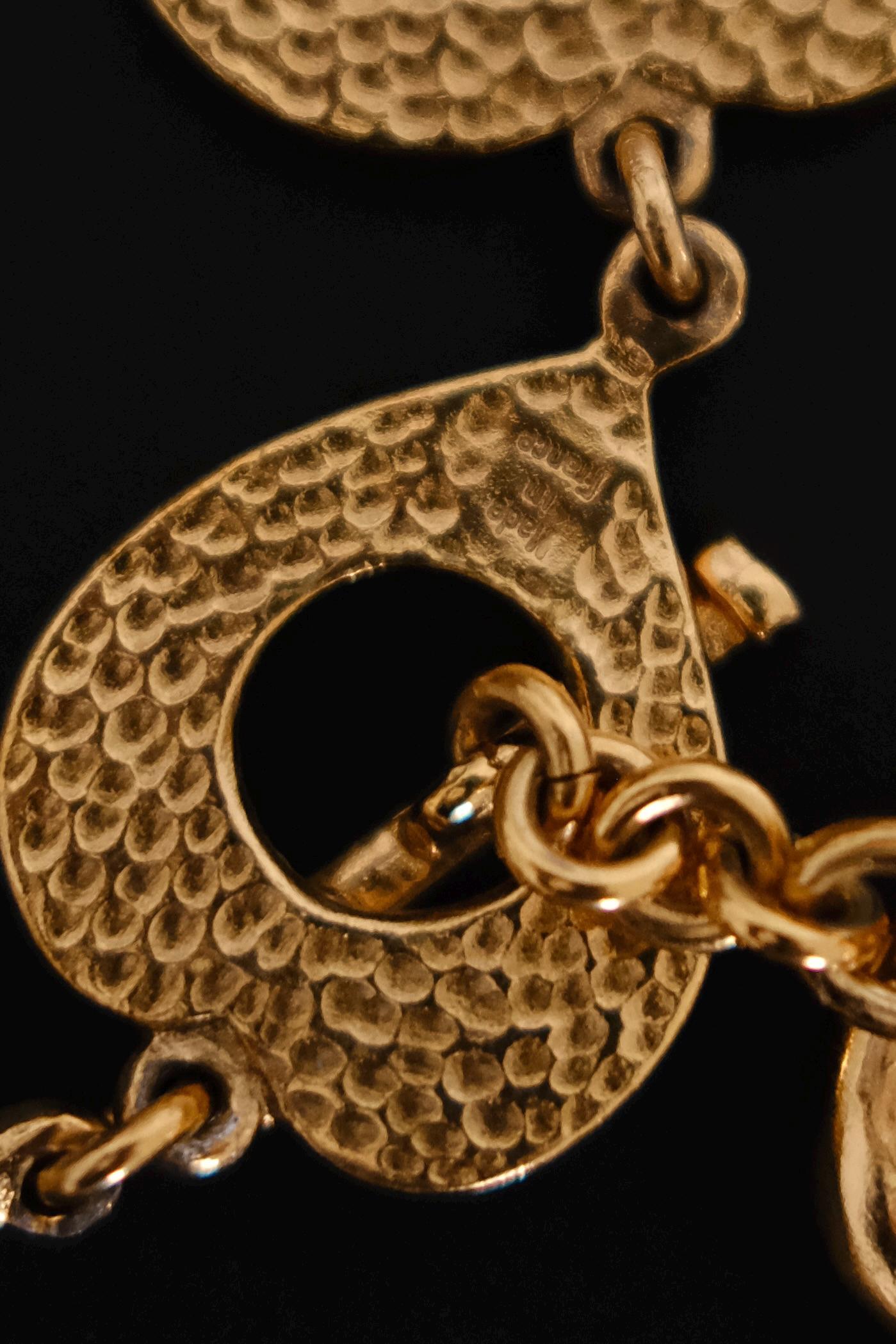 Decorative heart shaped toggle and loop closure on vintage Yves Saint Laurent gold choker necklace