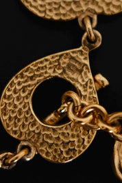 Decorative heart shaped toggle and loop closure on vintage Yves Saint Laurent gold choker necklace