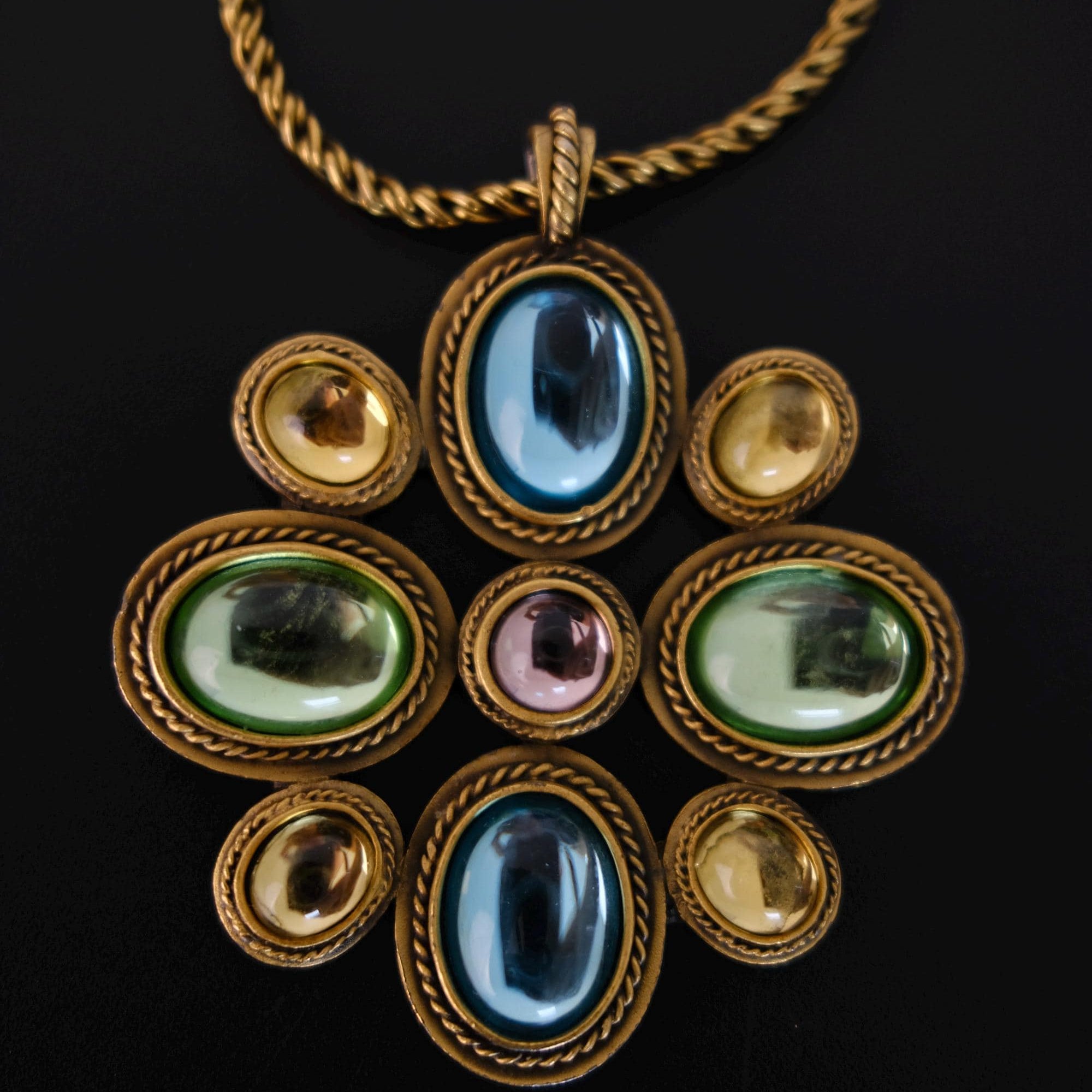 Vintage Yves Saint Laurent YSL long statement necklace with an ornate gold-tone pendant and multicolor blue, green, purple and amber cabochon stones
