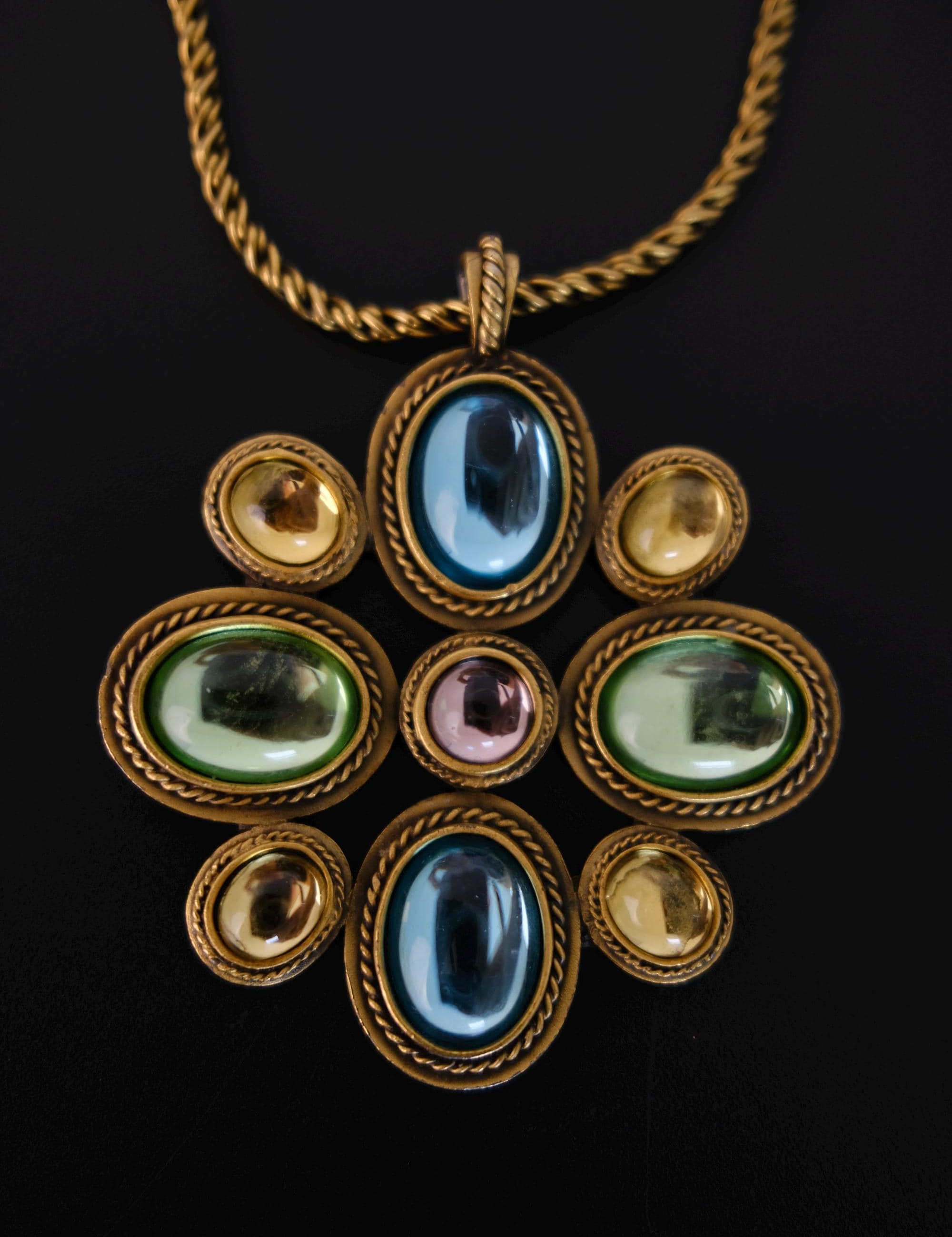 Vintage Yves Saint Laurent YSL long statement necklace with an ornate gold-tone pendant and multicolor blue, green, purple and amber cabochon stones