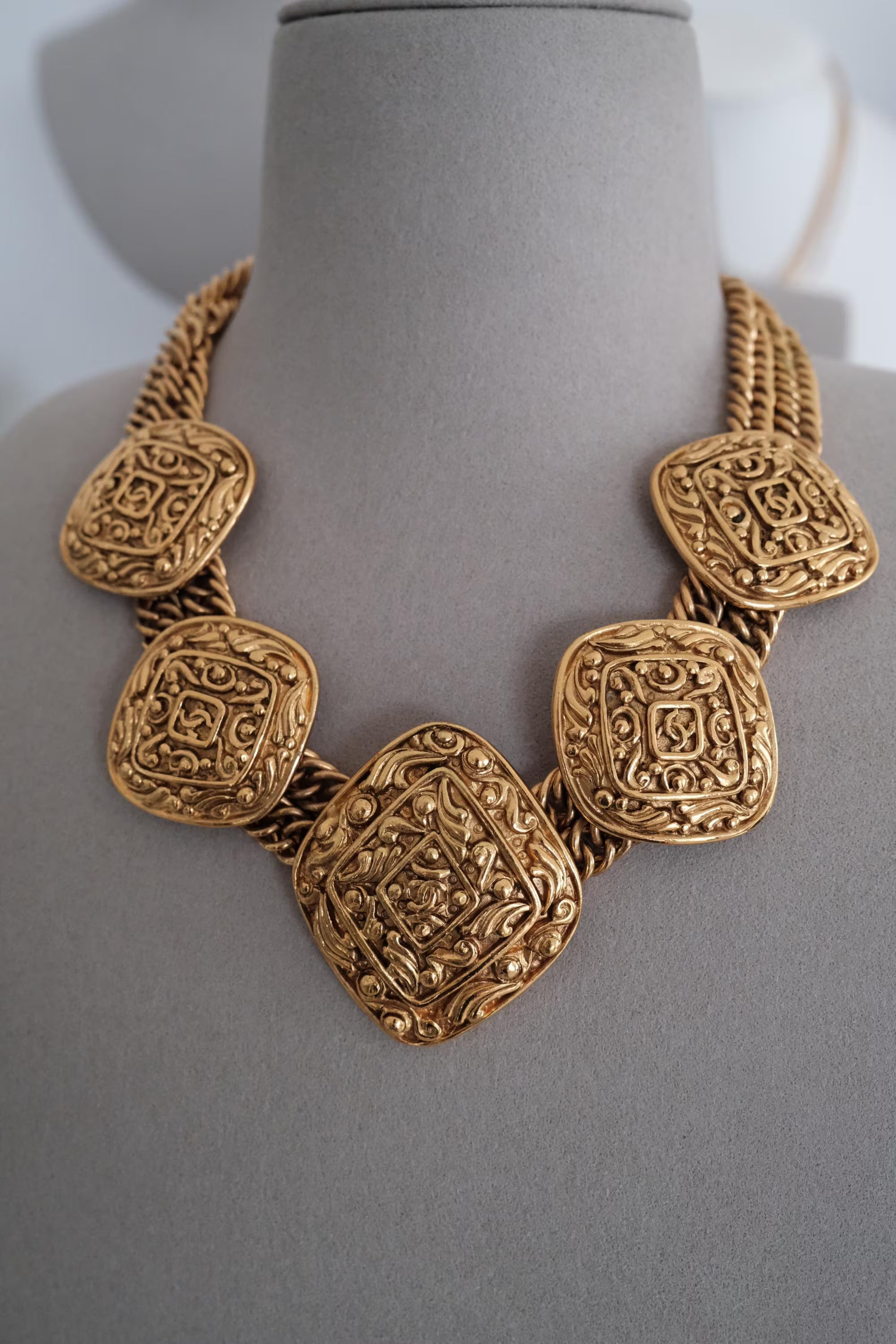 Authentic Chanel Paris sautoir medallion necklace worn as iconic statement jewelry