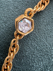 Close-up of Vintage Chanel CC crystal pendant necklace gold plated
