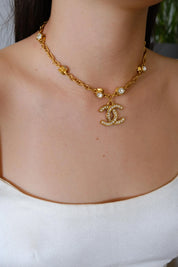 Vintage Chanel CC crystal pendant necklace worn as iconic statement jewelry