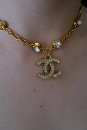 Vintage Chanel CC crystal pendant necklace worn as iconic statement jewelry