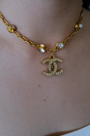 Vintage Chanel CC crystal pendant necklace worn as iconic statement jewelry