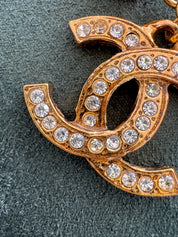 Close-up of Vintage Chanel CC crystal pendant necklace gold plated