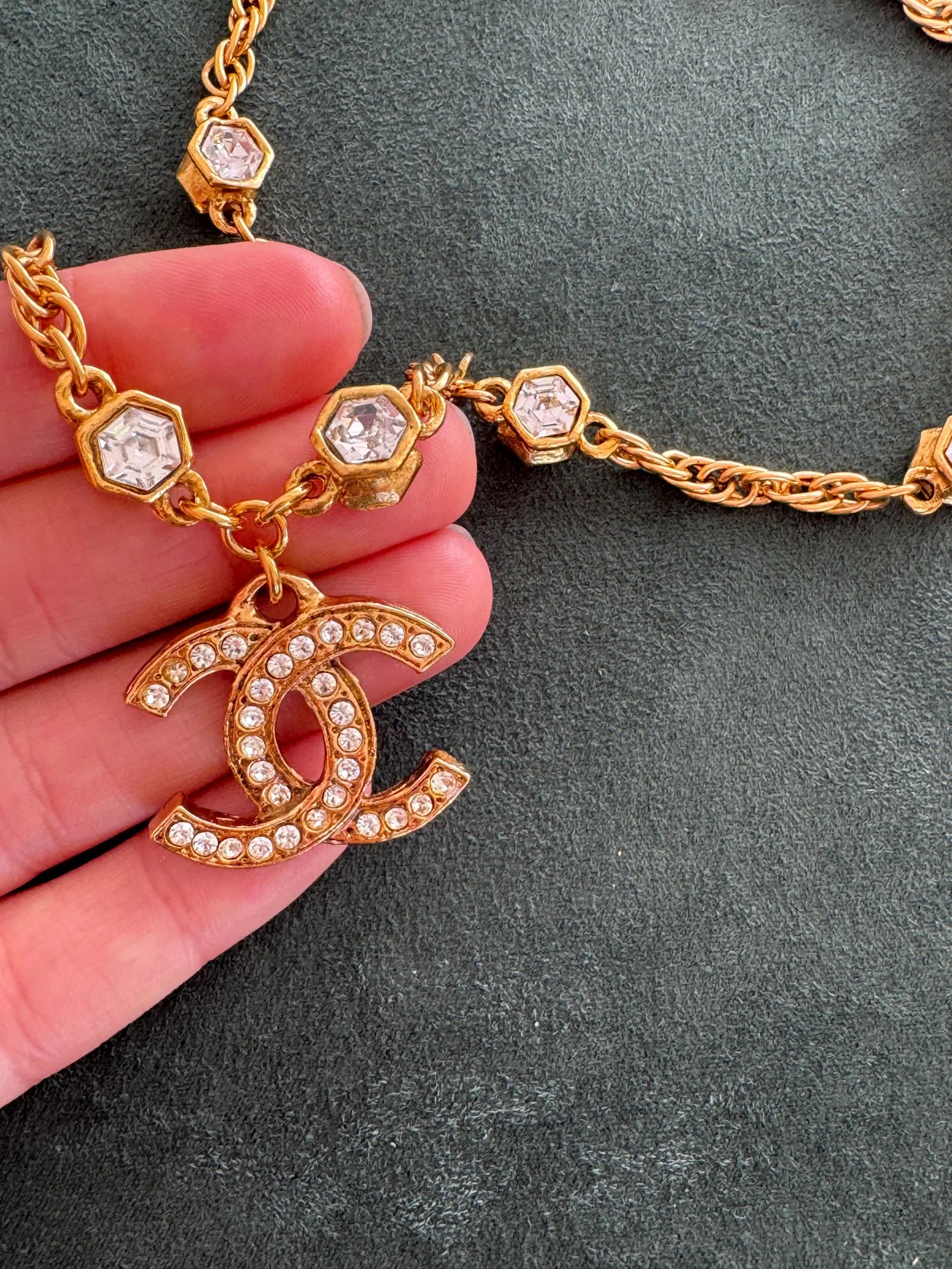 Close-up of Vintage Chanel CC crystal pendant necklace gold plated