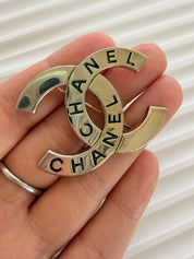 Authentic Chanel vintage CC brooch with light patina and elegant shine