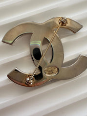 Authentic Chanel vintage CC brooch with light patina and elegant shine