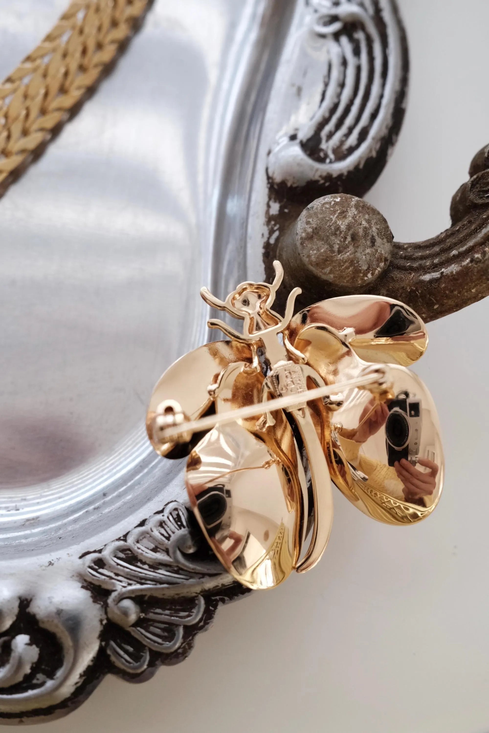 Close-up of Vintage Christian Dior dragonfly brooch pin in gold tone