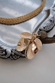 Vintage Christian Dior dragonfly brooch worn as bridal accessory