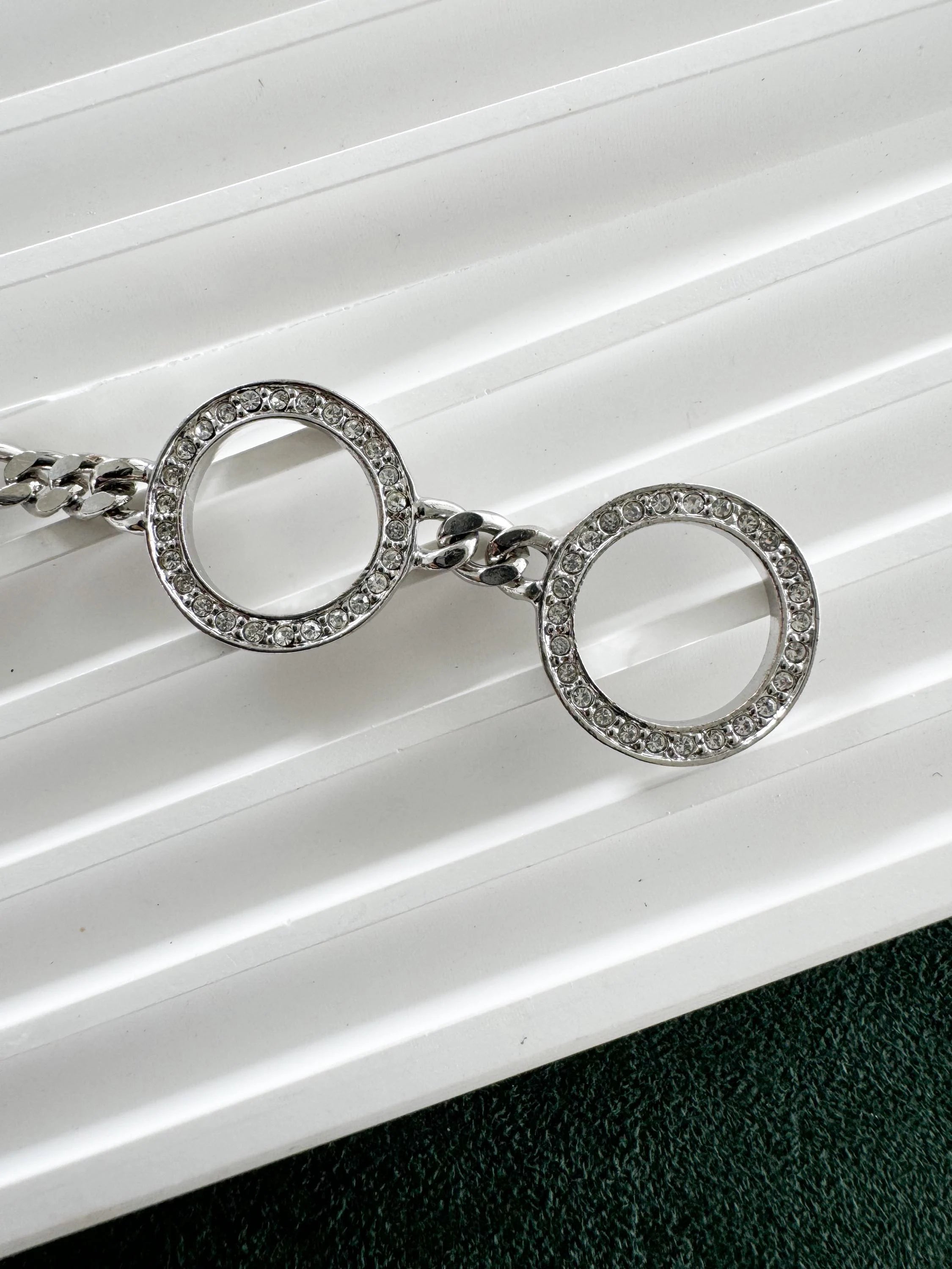 Close-up of Vintage Christian Dior rhinestone charm bracelet silver tone