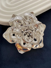 Close-up of layered petals on vintage Dior rose brooch high polish finish