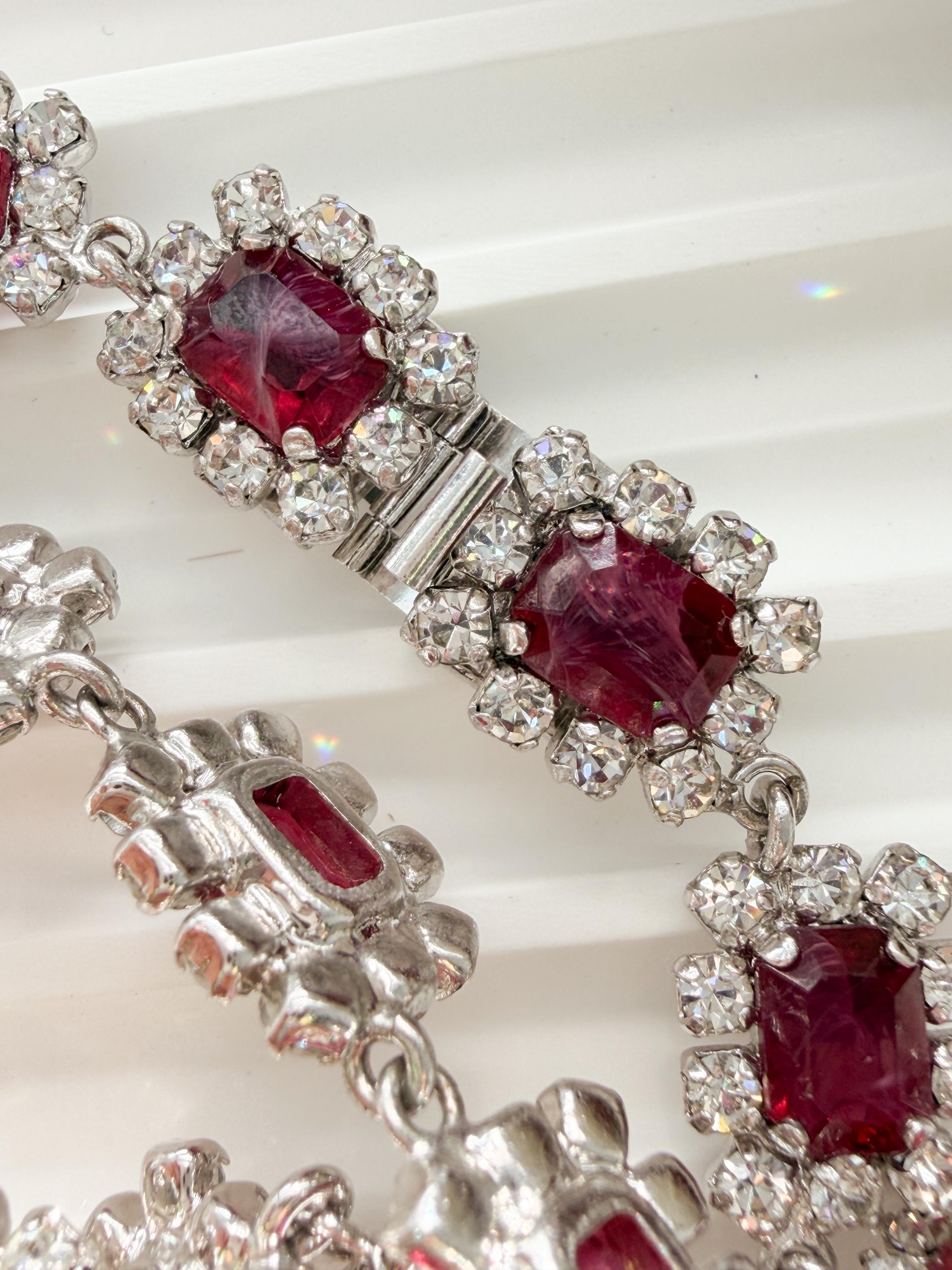 Close-up of ruby red crystals with rhinestone halo on vintage Dior necklace