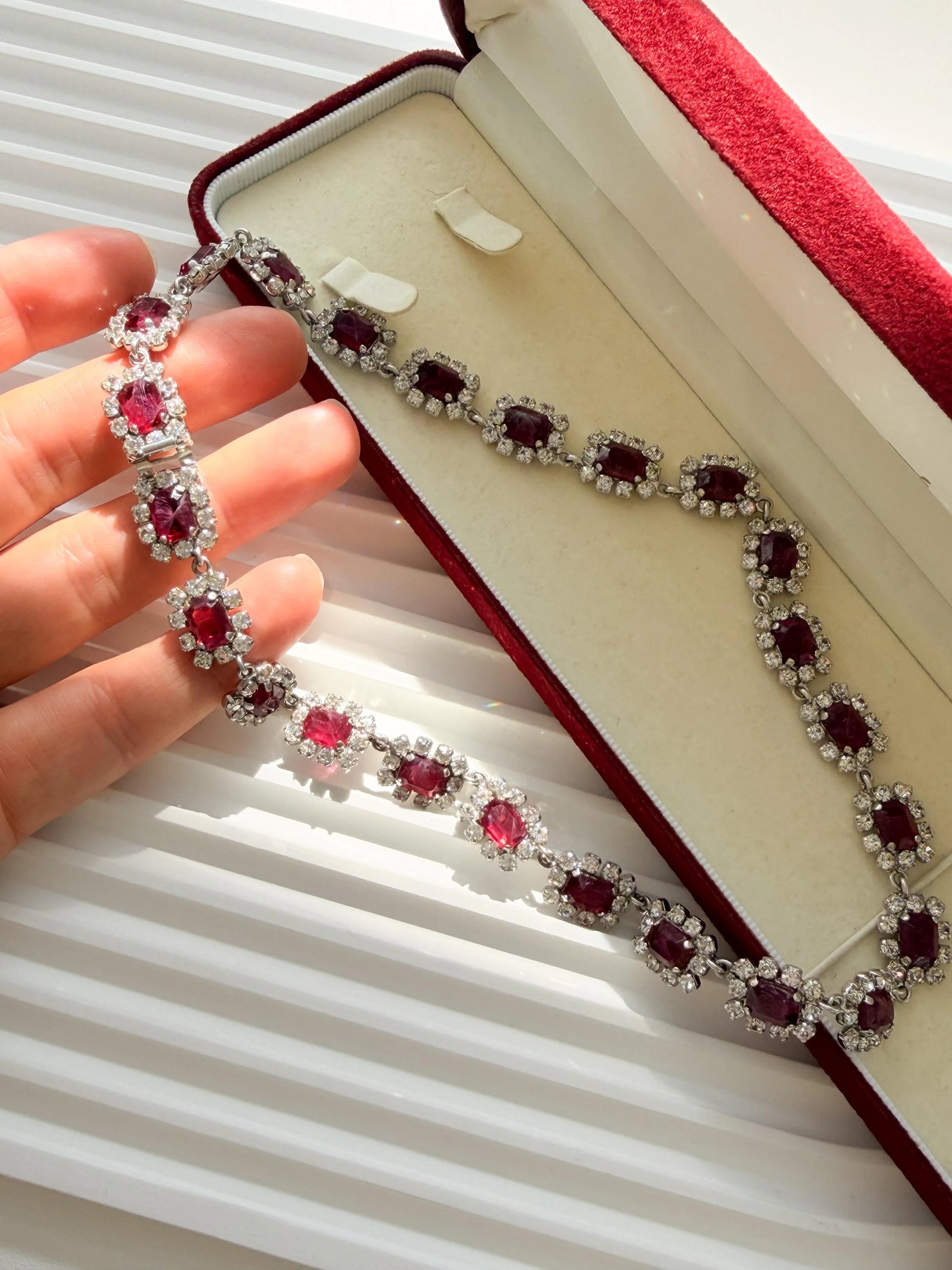 Vintage Dior necklace with luminous ruby crystals and refined silver tone setting