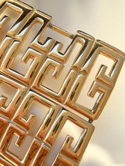 Close-up of Vintage Givenchy G logo monogram bracelet in gold tone