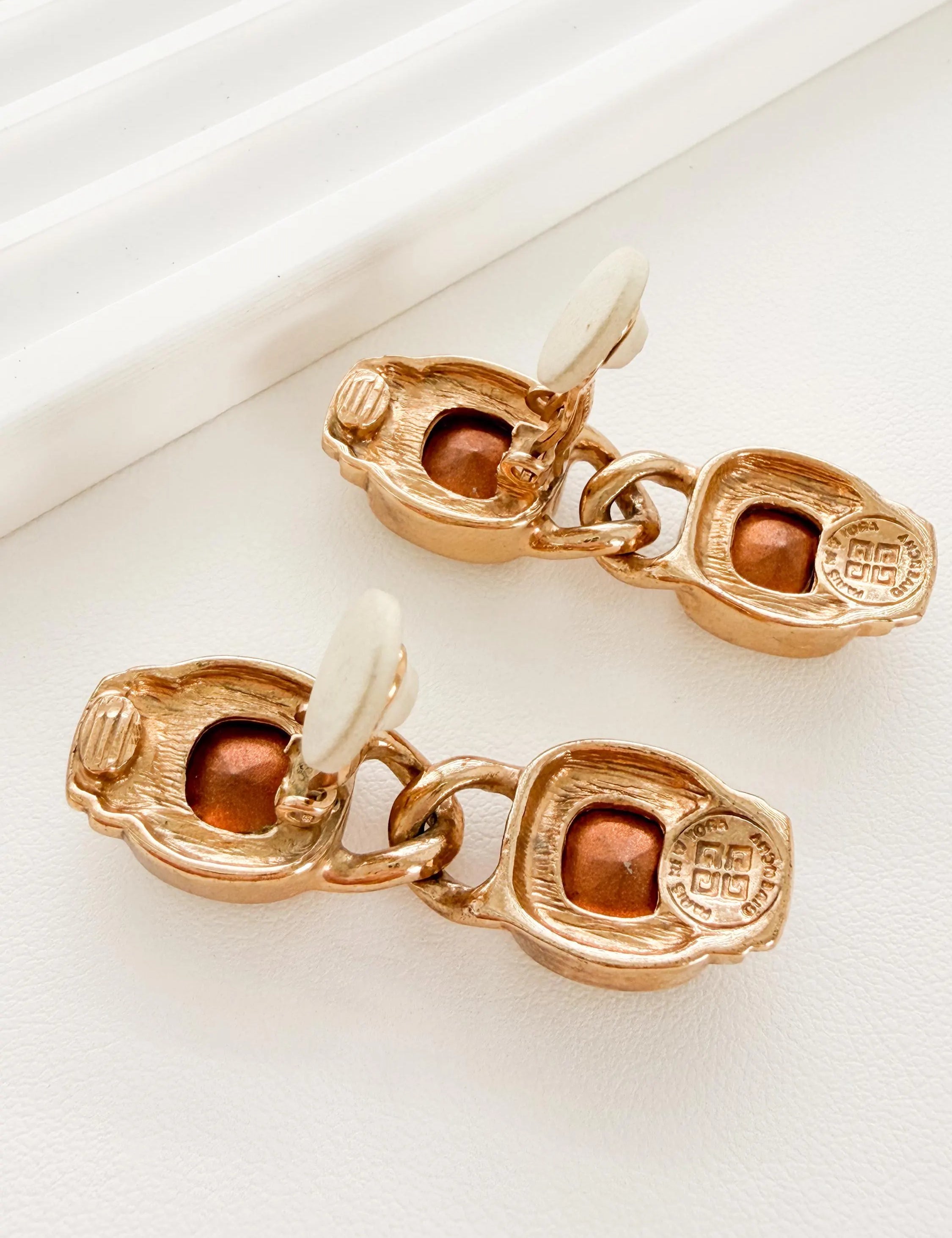 Close-up of faceted crystal stones on vintage Givenchy gold earrings