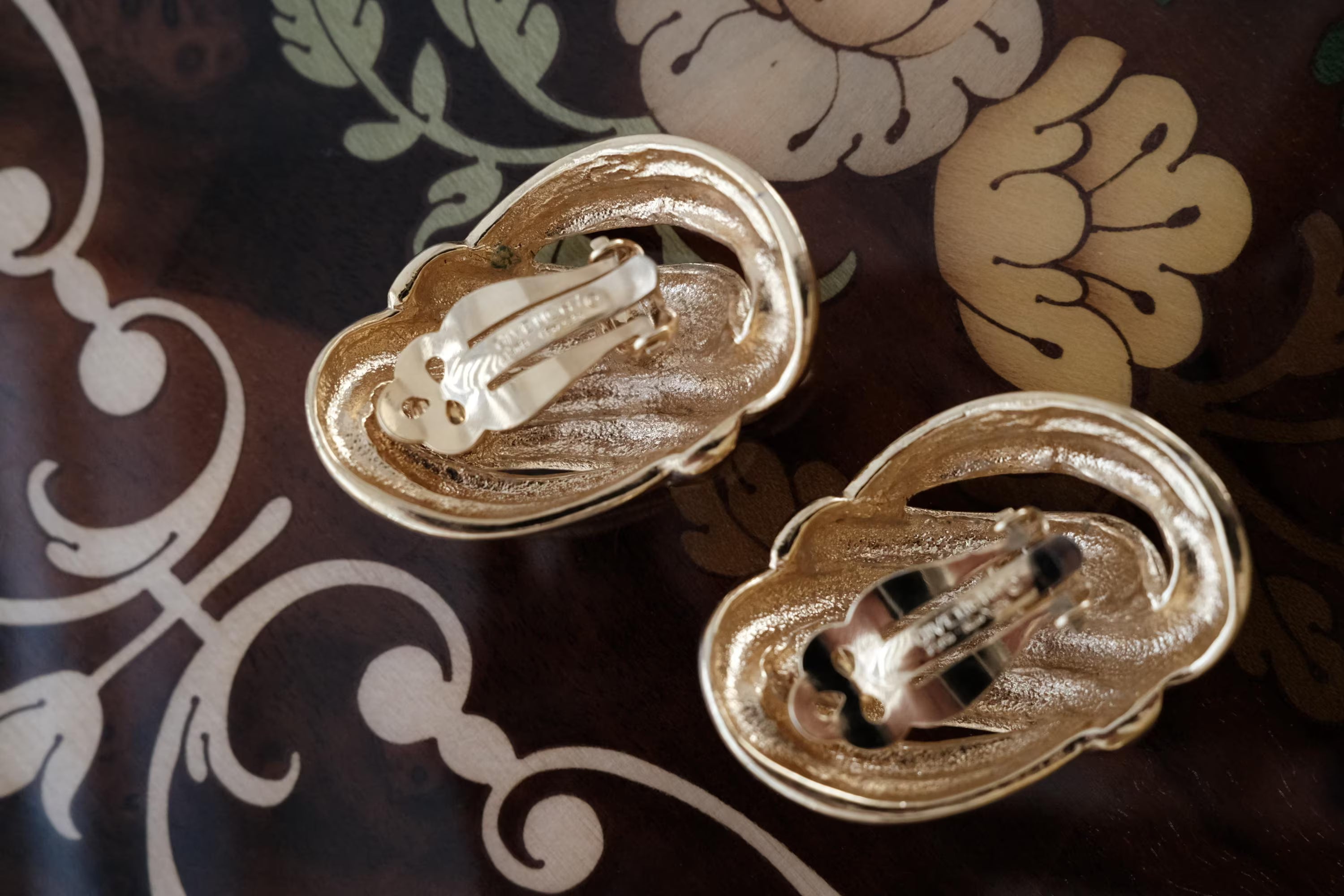 Side view of Vintage Givenchy Paris New York clip-on earrings with knot design