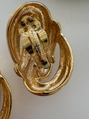 Close-up of Vintage Givenchy knot openwork clip-on earrings in gold tone