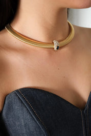 Vintage Nina Ricci Tubogas choker necklace in gold tone with sapphire-blue and clear crystals, elegant 1980s-style designer jewelry.
