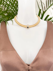 Vintage Nina Ricci Tubogas choker necklace in gold tone with sapphire-blue and clear crystals, elegant 1980s-style designer jewelry.